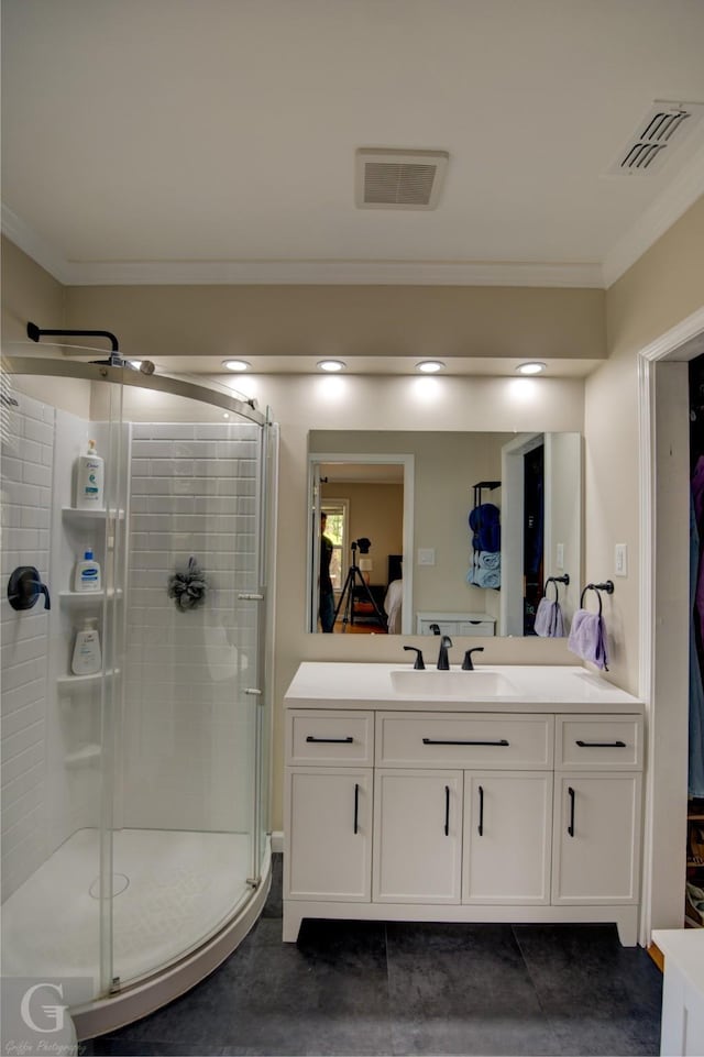 ensuite bathroom featuring ornamental molding, visible vents, vanity, and ensuite bathroom