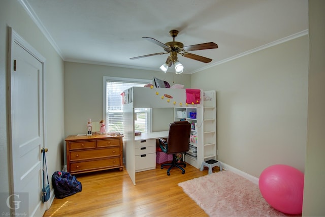 office space with baseboards, ceiling fan, light wood-type flooring, and crown molding