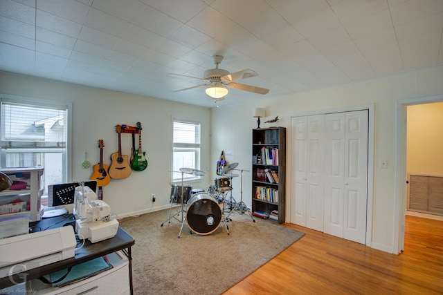 office space with baseboards, ceiling fan, visible vents, and light wood-style floors