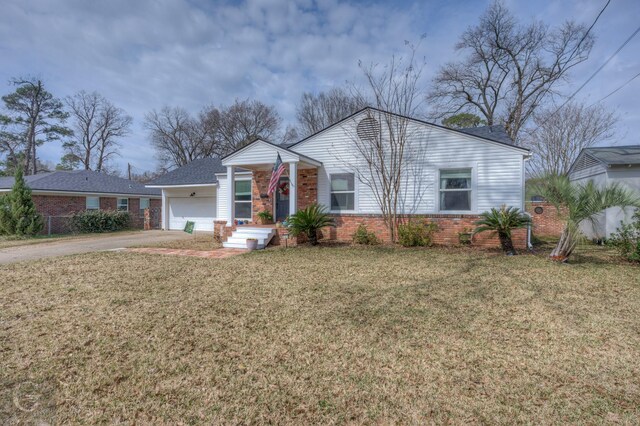 view of front facade featuring driveway, a garage, a front lawn, and brick siding