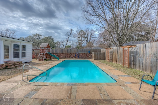 view of pool featuring entry steps, a fenced backyard, a fenced in pool, and a patio