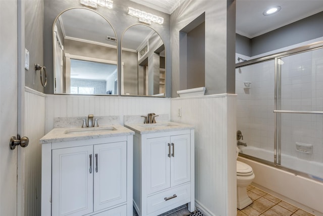 full bathroom featuring two vanities, wainscoting, a sink, and tile patterned floors