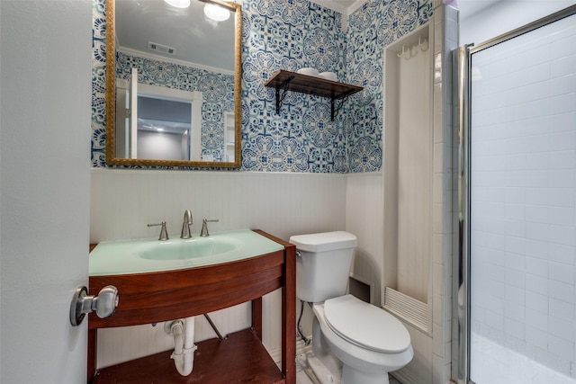 bathroom featuring wallpapered walls, visible vents, toilet, a wainscoted wall, and a shower stall