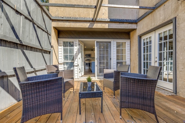 wooden terrace featuring french doors and an outdoor living space