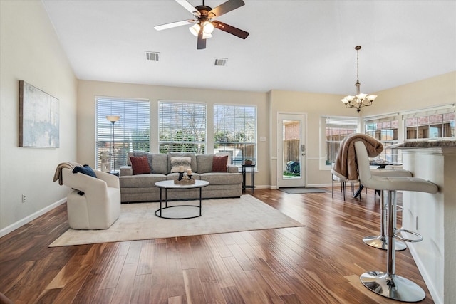 living room featuring visible vents, ceiling fan with notable chandelier, and wood finished floors