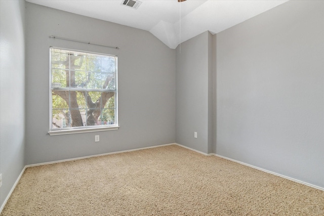 unfurnished room with visible vents, baseboards, a ceiling fan, and vaulted ceiling