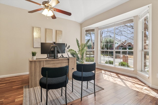 office area with lofted ceiling, wood finished floors, baseboards, and ceiling fan