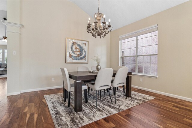 dining space with baseboards, a notable chandelier, wood finished floors, and high vaulted ceiling