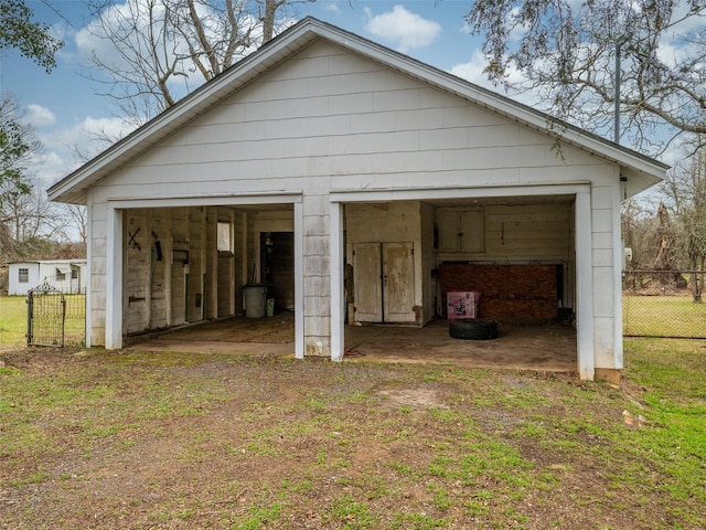 detached garage featuring fence