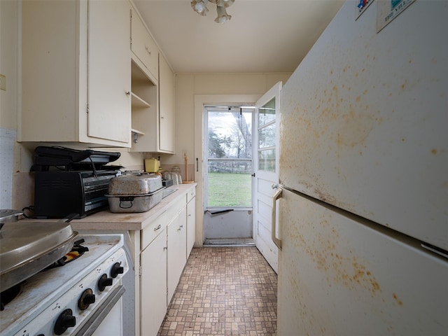 kitchen featuring a toaster, white appliances, white cabinetry, light countertops, and open shelves