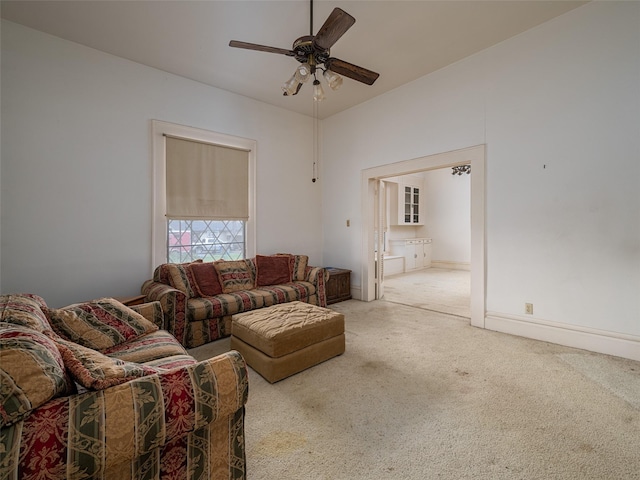 living room with carpet, ceiling fan, and baseboards