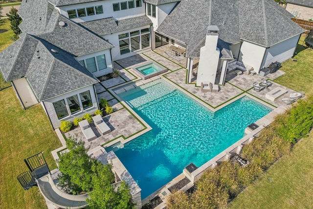 view of swimming pool with a fenced in pool, a lawn, a patio area, fence, and an in ground hot tub