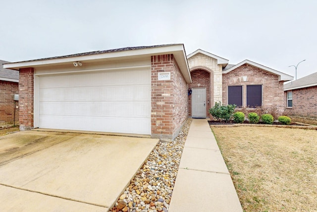 ranch-style home featuring a garage, driveway, and brick siding