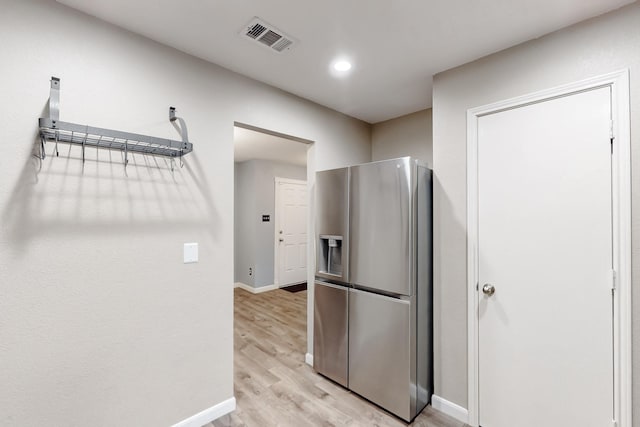 kitchen with recessed lighting, visible vents, baseboards, light wood-style floors, and stainless steel fridge with ice dispenser