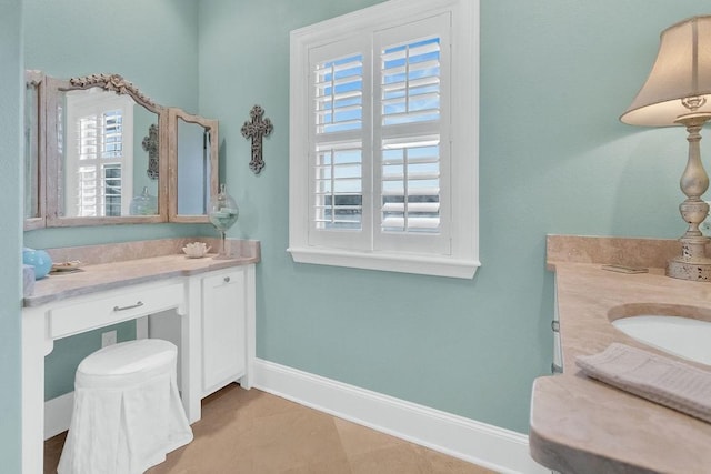 bathroom with plenty of natural light, vanity, and baseboards