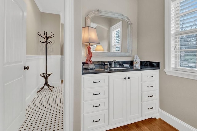 bathroom featuring wainscoting, vanity, and wood finished floors