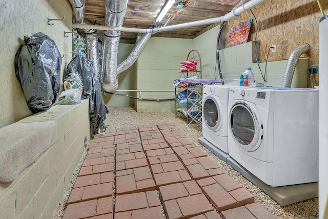 clothes washing area featuring laundry area and washer and clothes dryer