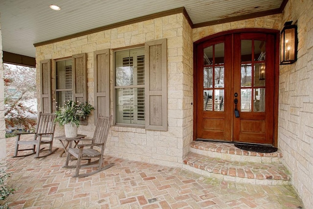 property entrance featuring french doors and a porch