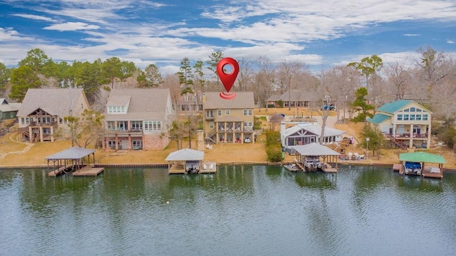 birds eye view of property with a water view and a residential view