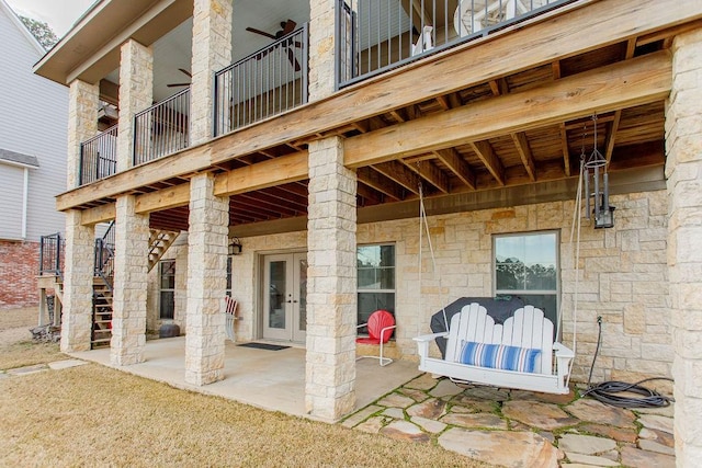 view of patio / terrace featuring french doors and stairway