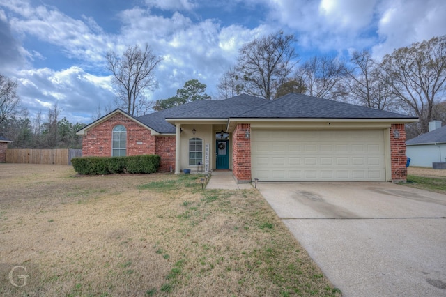 ranch-style house with a garage, brick siding, fence, driveway, and a front yard