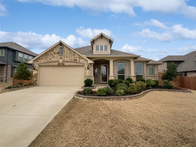 view of front of home featuring concrete driveway, stone siding, an attached garage, fence, and brick siding