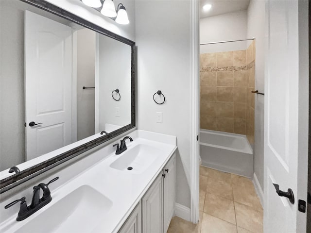 bathroom featuring double vanity, a sink, shower / tub combination, and tile patterned floors