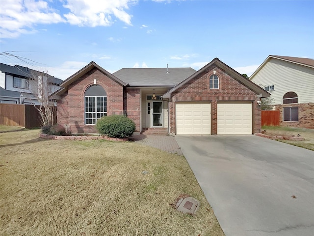 ranch-style home featuring an attached garage, fence, concrete driveway, and brick siding