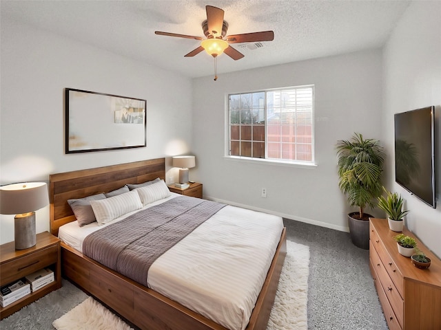 carpeted bedroom featuring visible vents, baseboards, ceiling fan, and a textured ceiling