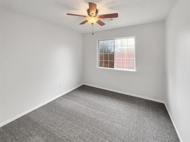 spare room featuring a textured ceiling, carpet floors, ceiling fan, and baseboards