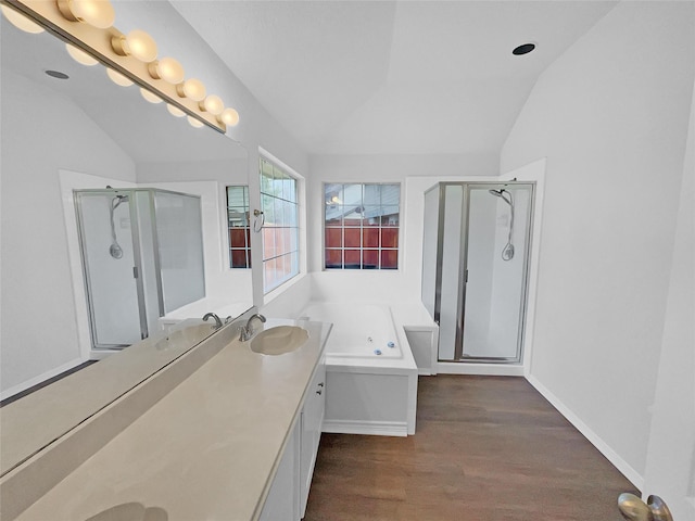 full bath with lofted ceiling, a shower stall, and wood finished floors