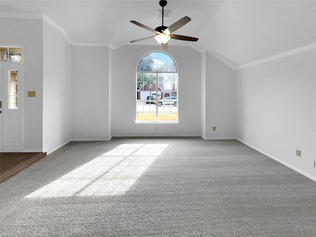 unfurnished room with carpet floors, a ceiling fan, visible vents, vaulted ceiling, and crown molding