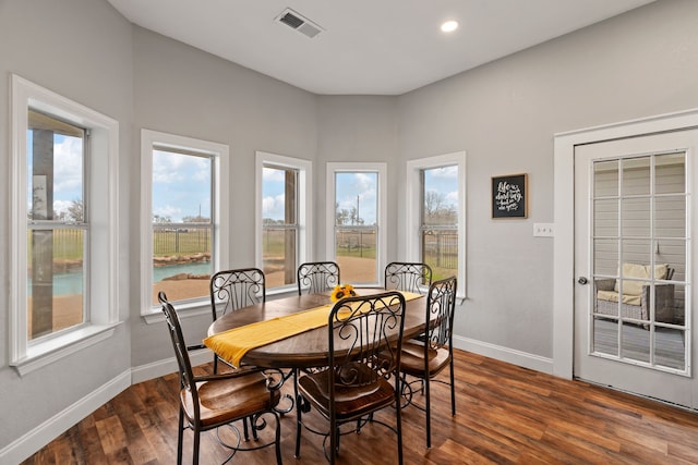 dining space featuring dark wood-style flooring, recessed lighting, visible vents, and baseboards