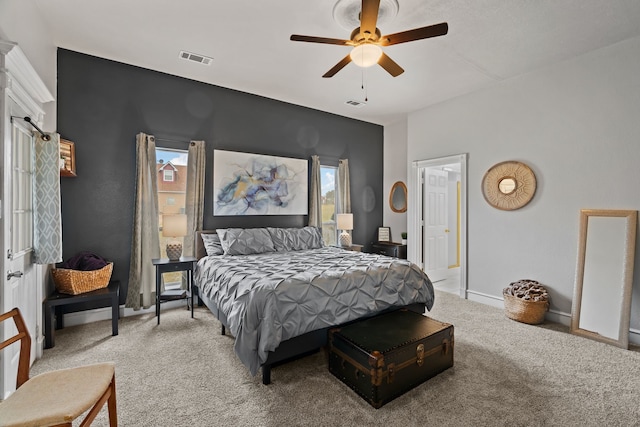 carpeted bedroom with a ceiling fan, visible vents, and baseboards