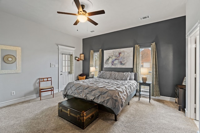 bedroom with carpet, multiple windows, visible vents, and baseboards