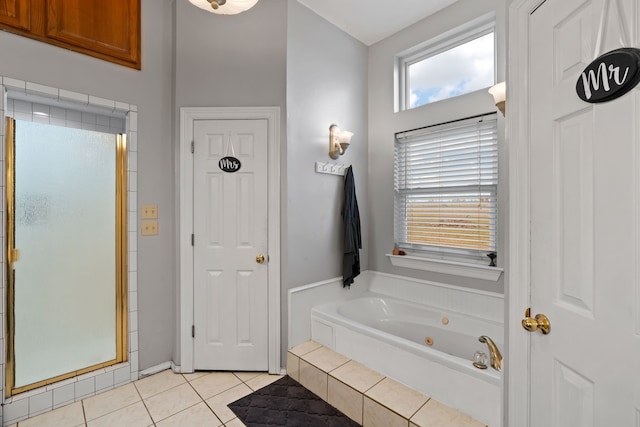 full bathroom featuring a jetted tub, a shower stall, and tile patterned flooring