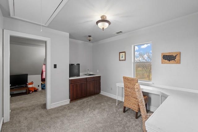 office featuring light carpet, attic access, baseboards, visible vents, and a sink