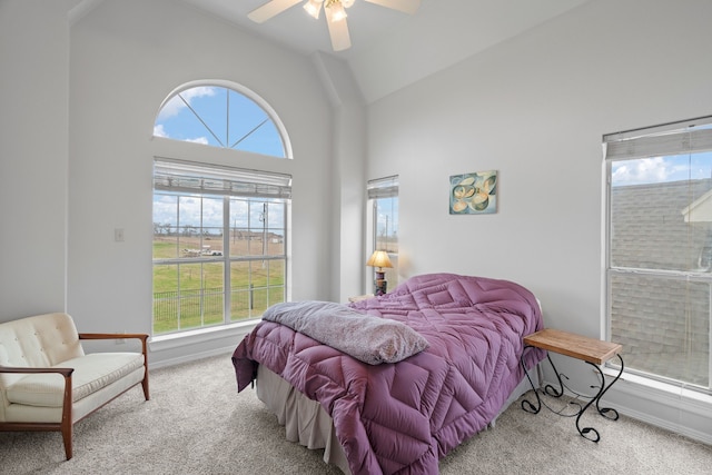 carpeted bedroom with lofted ceiling, ceiling fan, and baseboards