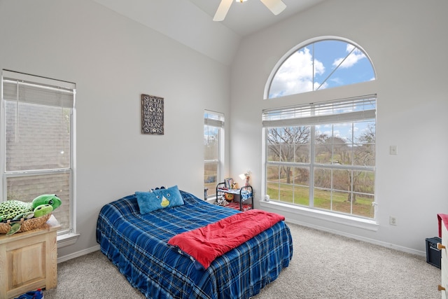 carpeted bedroom featuring vaulted ceiling, multiple windows, ceiling fan, and baseboards