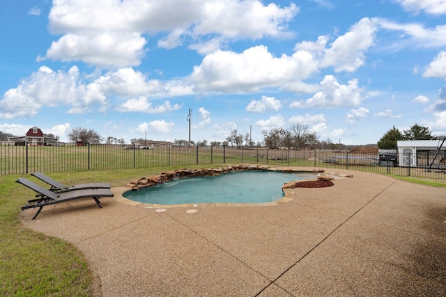 view of swimming pool with a fenced backyard, a yard, and a patio