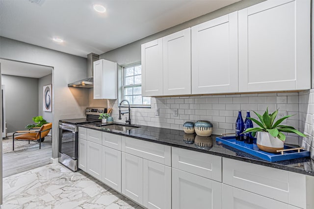 kitchen featuring a sink, marble finish floor, dark stone counters, and electric stove