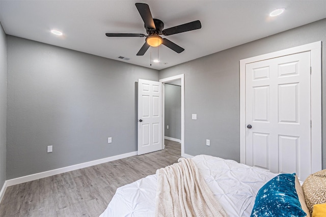 bedroom with recessed lighting, visible vents, ceiling fan, wood finished floors, and baseboards