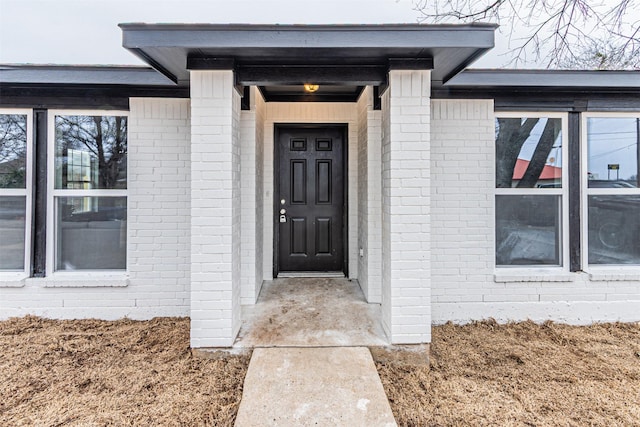 property entrance with brick siding