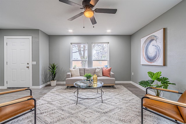 living area with ceiling fan, baseboards, wood finished floors, and recessed lighting