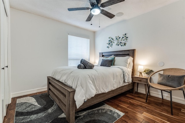 bedroom with a ceiling fan, baseboards, and wood finished floors