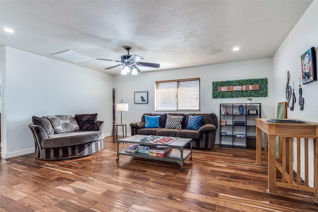 living room with a textured ceiling, recessed lighting, wood finished floors, a ceiling fan, and baseboards