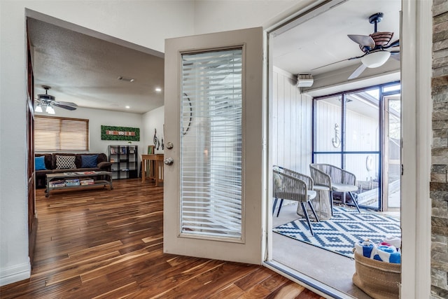 doorway to outside with ceiling fan and wood finished floors