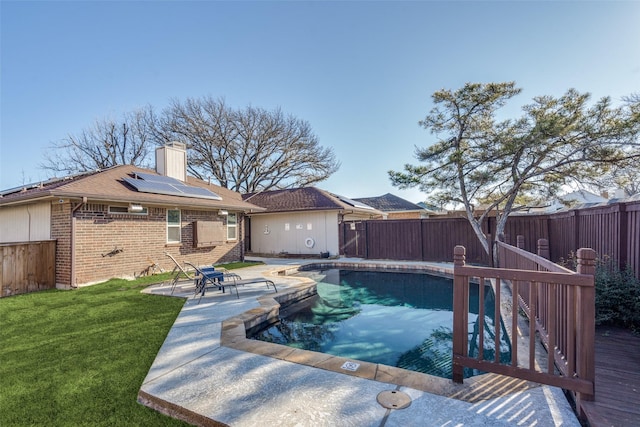 view of swimming pool with a yard, a fenced backyard, a fenced in pool, and a patio