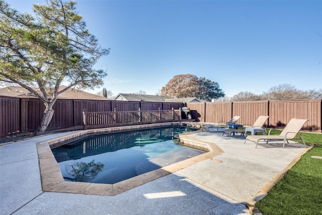 view of swimming pool with a fenced in pool, a fenced backyard, and a patio