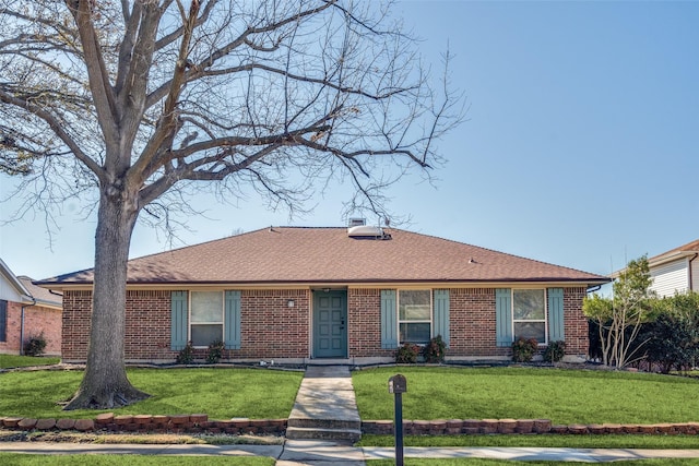 single story home with brick siding and a front yard